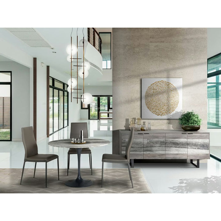 Modern dining room with a round table, chairs, and decorative wall art.