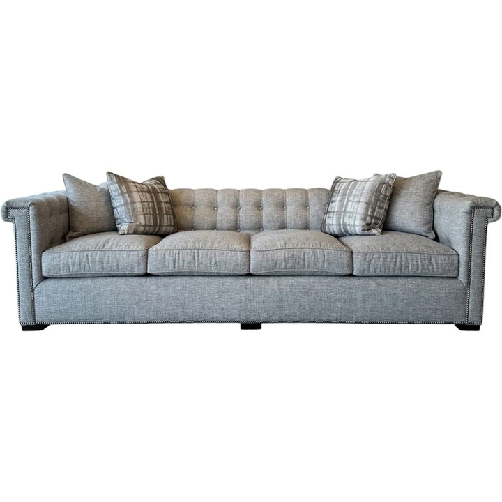 Gray sofa with patterned cushions on a white background