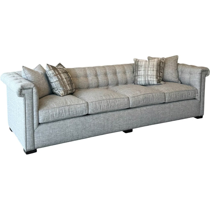 Gray sofa with patterned cushions on a white background