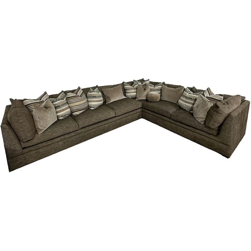 Brown sectional sofa with patterned cushions on a white background