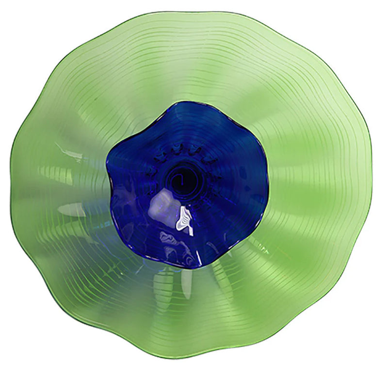 Green and blue glass wall plate on a white background