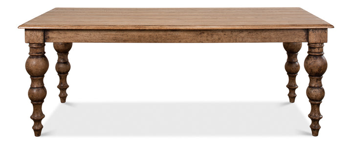 Wooden dining table with turned legs on a white background