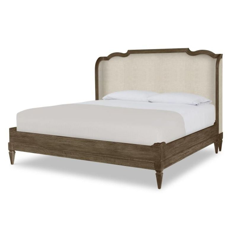 Wooden bed with upholstered headboard on a white background