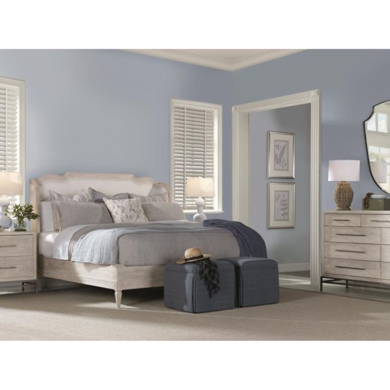 Neatly arranged bedroom with a bed, nightstands, and dresser.