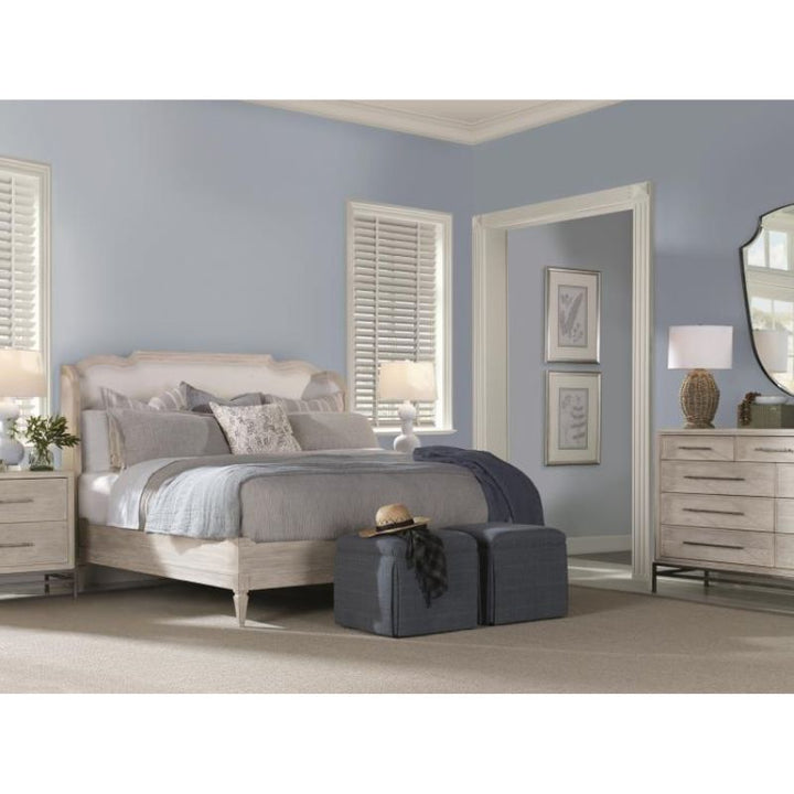 Neatly arranged bedroom with a bed, nightstands, and dresser.