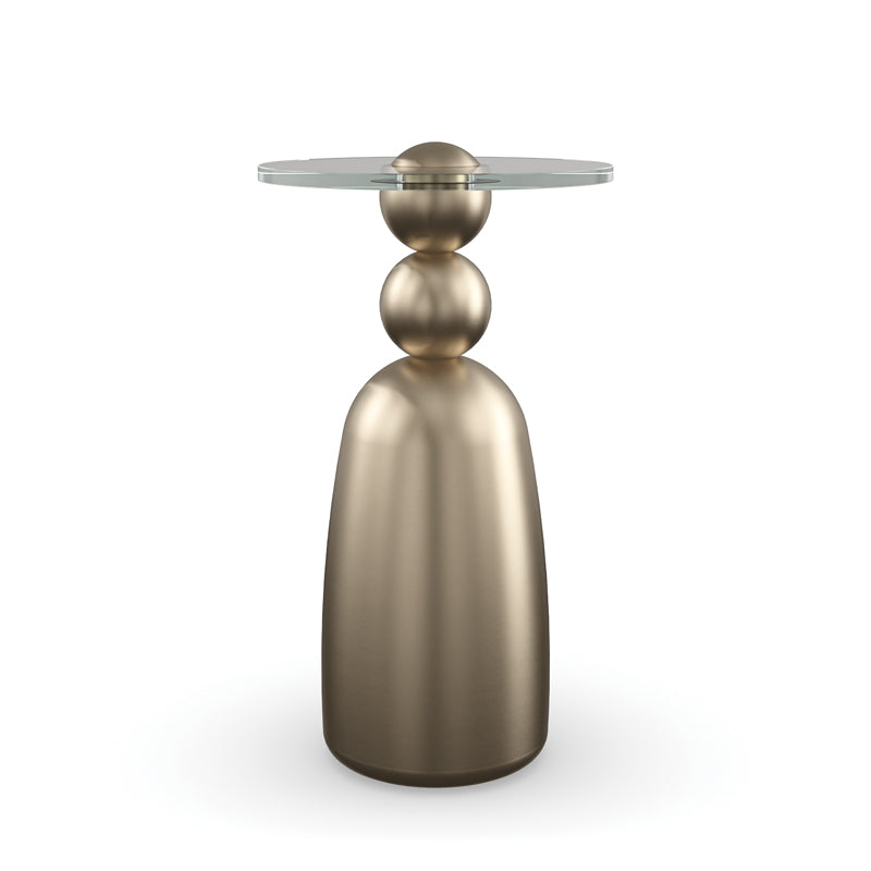 Bronze side table with a round glass top on a white background